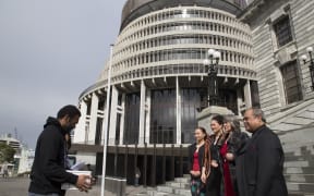 Pala Molisa and Tere Harrison present a petition on West Papua to New Zealand MPs Marama Davidson, Lousia Wall, Catherine Delahunty and Su'a William Sio, outside the country's parliament. 6 September 2016.