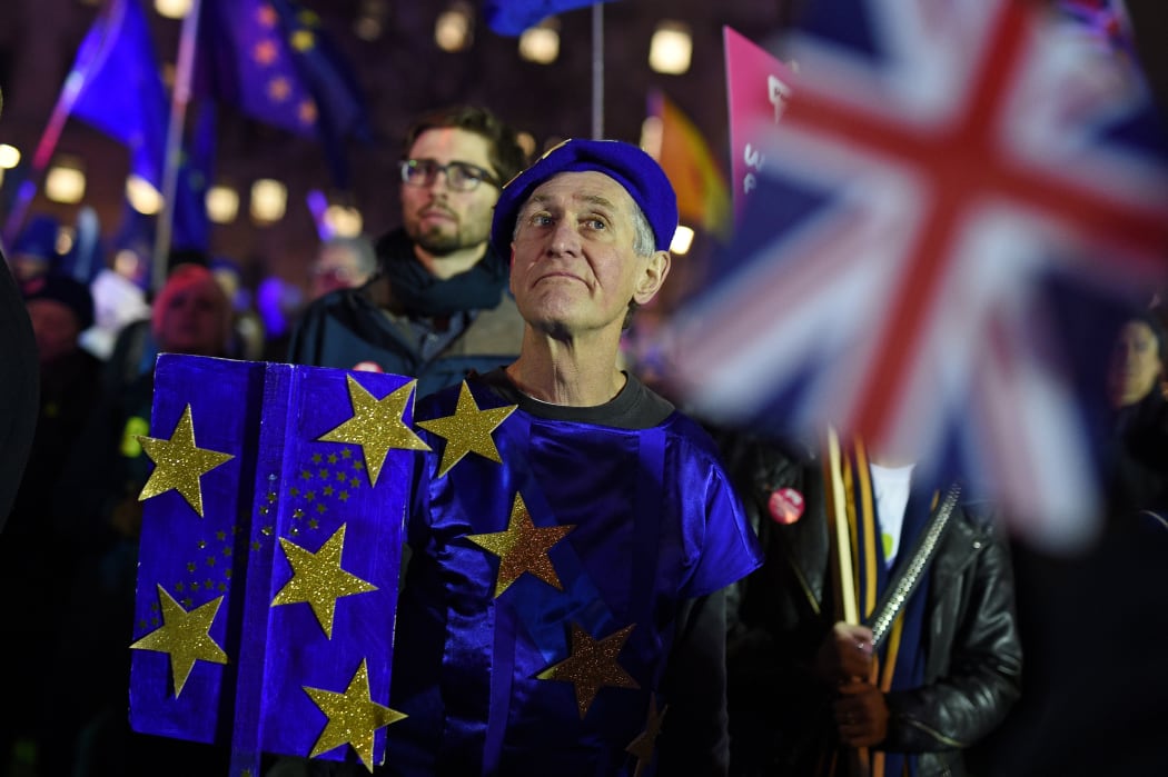 Anti-Brexit activists demonstrate with other protesters outside of the Houses of Parliament in central London on January 15, 2019.