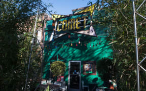 The sign for the Comet Ping Pong restaurant is seen in Washingon, DC, on December 5, 2016. An assault rifle-wielding gunman's appearance at a Washington pizzeria that was falsely reported to house a pedophile ring has elevated worries over the unrelenting rise of fake news and malicious gossip on the internet. No one was injured when 28-year-old Edgar Maddison Welch strode into the Comet Ping Pong restaurant, packed with families on a Sunday afternoon, and fired off a round from his AR-15. (Photo by NICHOLAS KAMM / AFP)