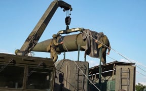 In this photo released by Russian Defense Ministry Press Service on Tuesday, May 21, 2024, Russian troops load an Iskander missile as part of drills to train the military for using tactical nuclear weapons at an undisclosed location in Russia. Russia's Defense Ministry on Tuesday said it began the first round of drills involving tactical nuclear weapons. It was the first time Russia has publicly announced drills involving tactical nuclear weapons, although its strategic nuclear forces regularly hold exercises. (Russian Defense Ministry Press Service via AP)