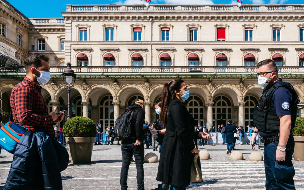 Access to the Gare de l Est train station in Paris is controlled by police officers and SNCF railway security agents on 14 May. They request certificates to move at peak hours, and maintain a distance of one metre.