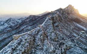 (230219) -- BEIJING, Feb. 19, 2023 (Xinhua) -- This aerial photo taken on Feb. 19, 2023 shows snow scenery of the Simatai section of the Great Wall at sunrise in Beijing, capital of China. (Xinhua/Cai Yang) (Photo by Cai Yang / XINHUA / Xinhua via AFP)