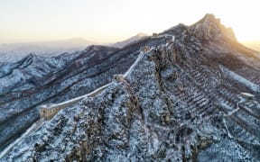 (230219) -- BEIJING, Feb. 19, 2023 (Xinhua) -- This aerial photo taken on Feb. 19, 2023 shows snow scenery of the Simatai section of the Great Wall at sunrise in Beijing, capital of China. (Xinhua/Cai Yang) (Photo by Cai Yang / XINHUA / Xinhua via AFP)