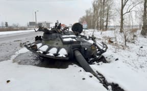 A fragment of a destroyed Russian tank is seen on the roadside on the outskirts of Kharkiv on February 26, 2022, following the Russian invasion.