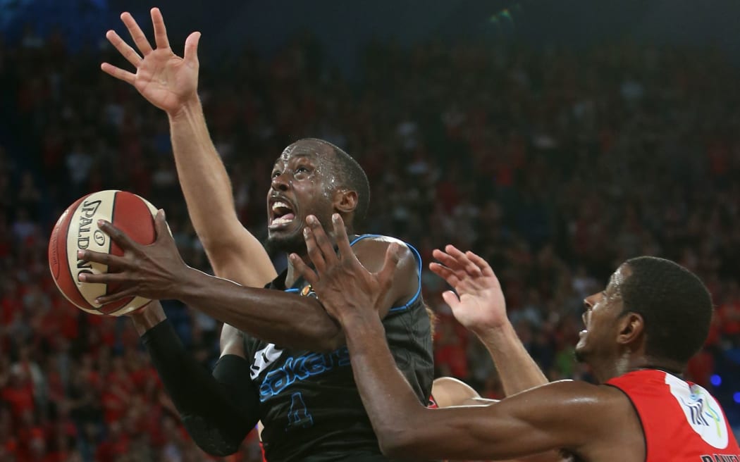 Breakers Cedric Jackson drives to the hoop during past Perth Wildcat DeAndre Daniels. Perth. 10th October 2014.