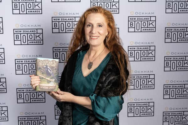 Catherine Chidgey holds a copy of her Ockham New Zealand Book Award-winning novel, The Axeman's Carnival.