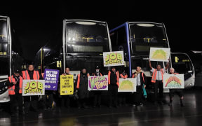 Bus drivers at the New Lynn depot hold placards as they take strike action on Tuesday 11 July 2023.