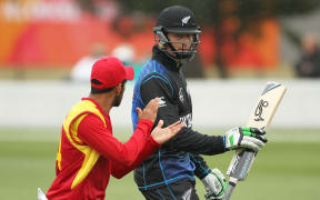 Raza Butt applauds Martin Guptill off Bert Sutcliffe Oval after he scored 100