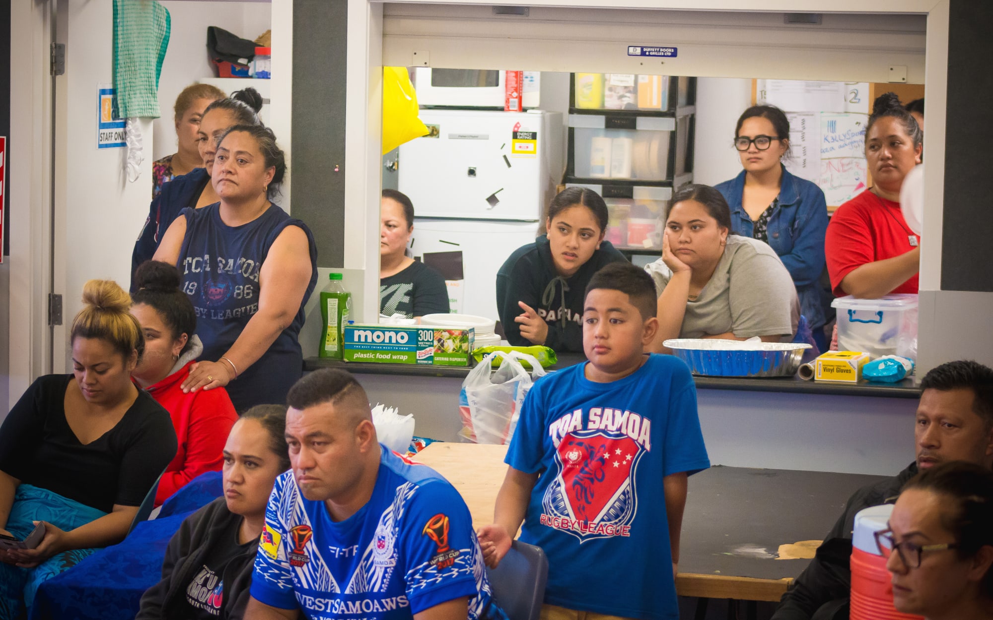 Parents and family watch on as their sons practice for Polyfest.