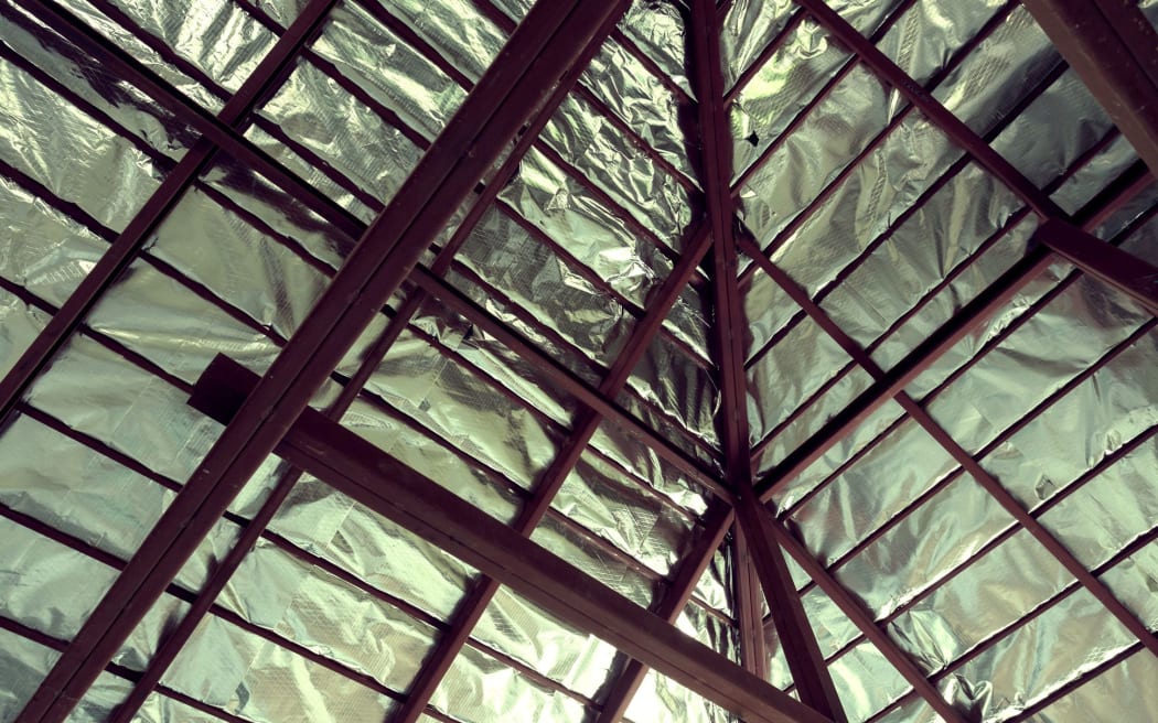 Roof with steel beam and silver foil insulation heat on ceiling roof house, image used filter vintage.