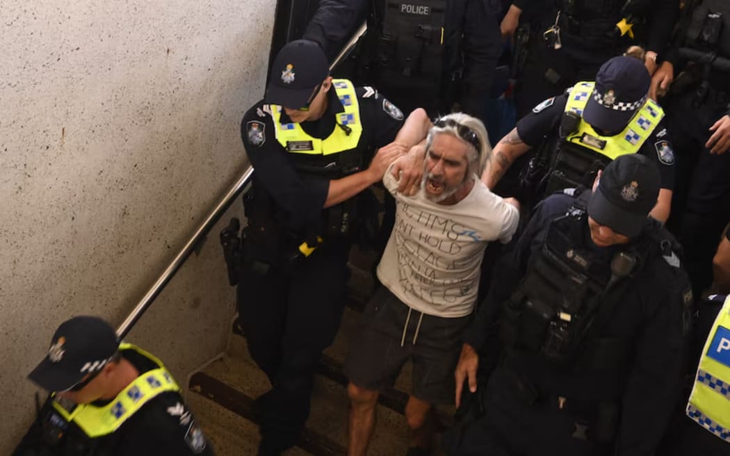 A counter-protester was escorted away by police after snatching a Palestinian flag.