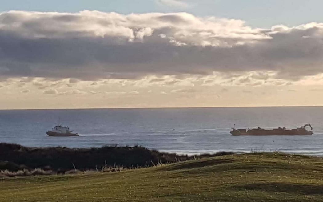 A sand-mining dredge in action off Pākiri Beach.