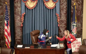 A protester sits in the Senate Chamber on January 06, 2021 in Washington, DC.