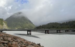 The northern bank of the Waiho River showing the current Waiho River bailey bridge.