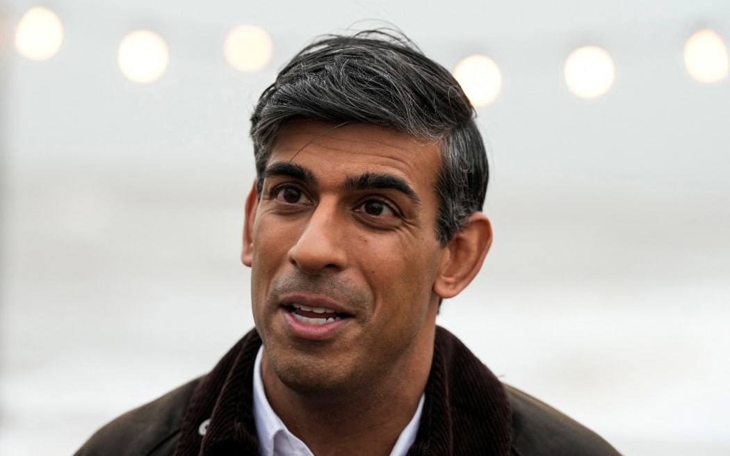 Britain's Prime Minister Rishi Sunak speaks to a TV reporter  during a visit to Clacton-on-Sea, south east England, on October 18, 2023. (Photo by Frank Augstein / POOL / AFP)