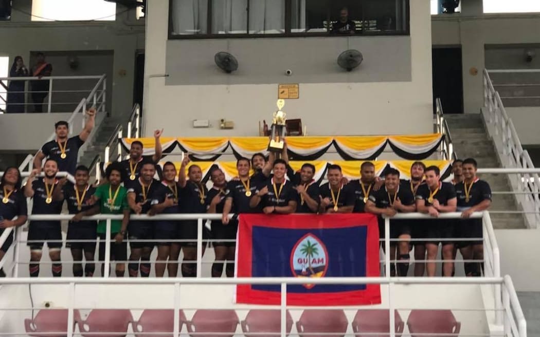 Guam lift the Asia Rugby Championship Division III East trophy.