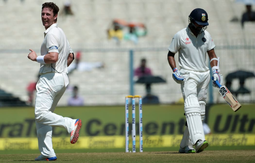 New Zealand's Matt Henry(L) celebrates after taking the wicket of India's Murali Vijay(R) during the first day of the second Test match between India and New Zealand at The Eden Gardens Cricket Stadium in Kolkata on September 30,