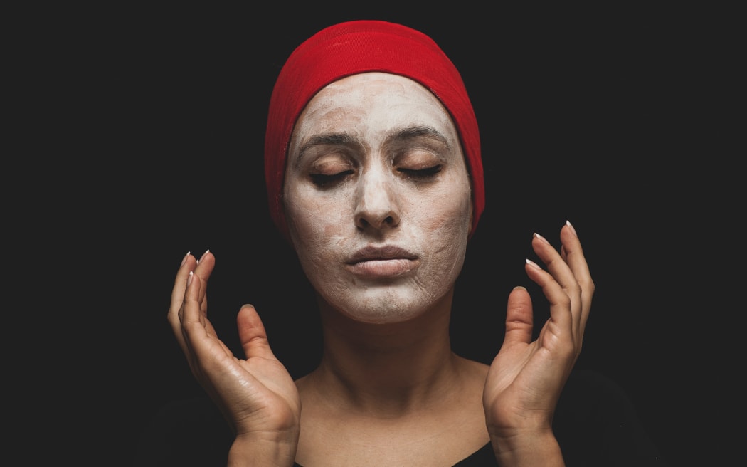 Woman in cosmetic face mask