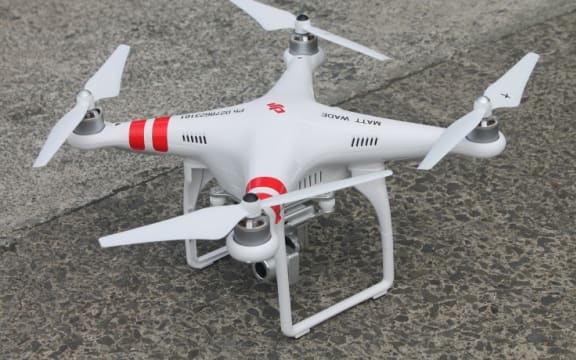 A closeup image Karekare Surf Life Saving Club's new drone, sitting on conccrete outside the club.
