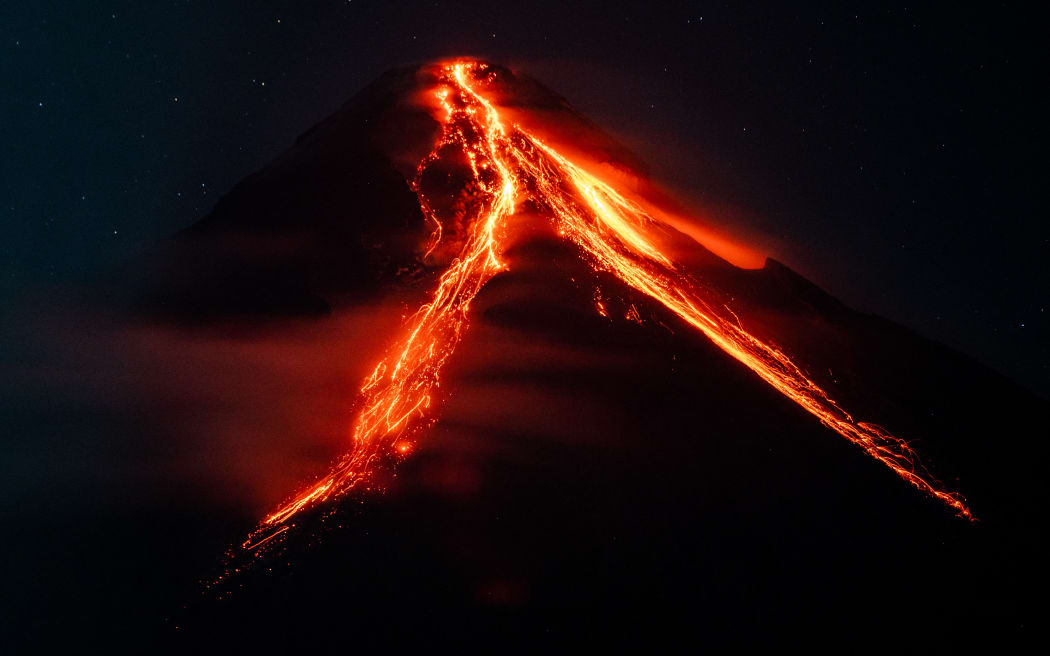 Lava and ashes flow from the Mayon Volcano which remains under alert level 3, in Daraga, Albay province, Philippines, on June 12, 2023. (Photo by Lisa Marie David/NurPhoto) (Photo by Lisa Marie David / NurPhoto / NurPhoto via AFP)