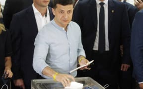 Ukrainian President Volodymyr Zelensky casts a ballot at a polling station for voting during the Parliamentary elections in Kiev, Ukraine, on 21 July, 2019.