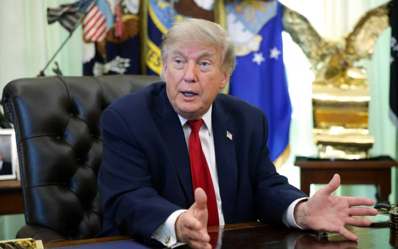 US President Donald Trump talks to reporters after signing an executive order dealing with automobile repairs in the Oval Office at the White House on 29 June, 2026 in Washington, DC.