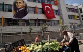 A street seller pushes his cart with fruits and vegetables next to a religious school in the Kasimpasa neighborhood in Istanbul where Turkish President Recep Tayyip Erdogan was born.