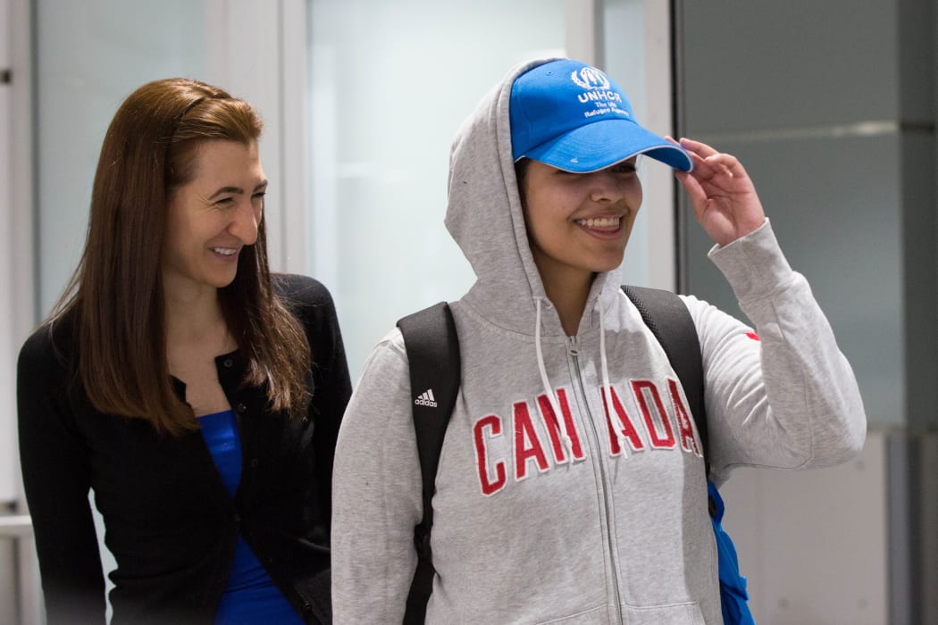 Saudi teenager Rahaf Mohammed al-Qunun (R) arrives at Pearson International airport in Toronto, Ontario.