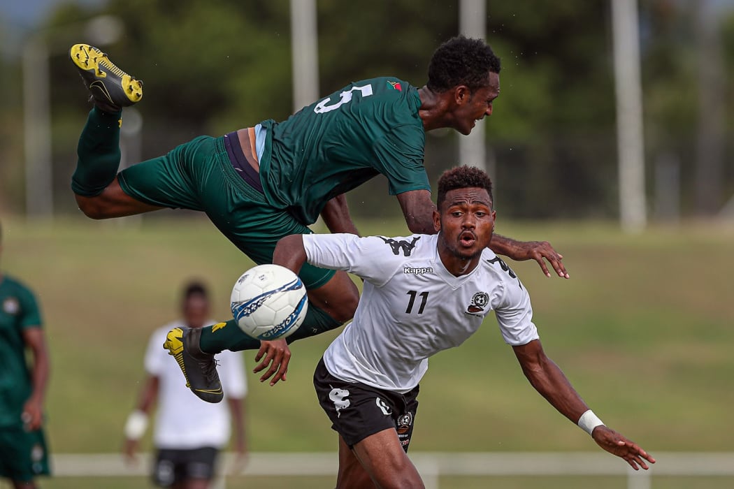 Vanuatu's Joseph Iaruel collides with Fiji's Tito Vodowaqa
