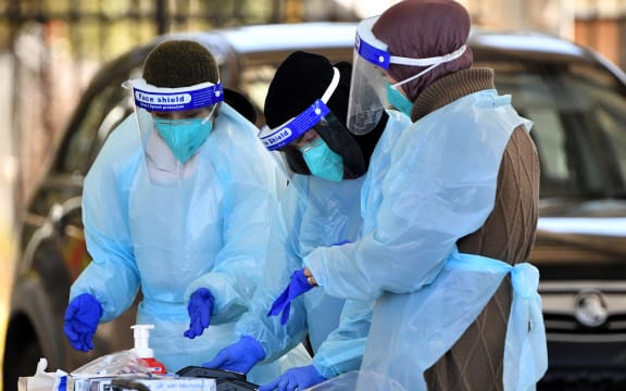 Health workers taking swab samples from residents at a Covid-19 drive-through testing clinic in Sydney on 28 July, 2021.