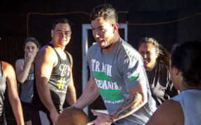 Levi Armstrong has possession while playing basketball with other Patu whanau.