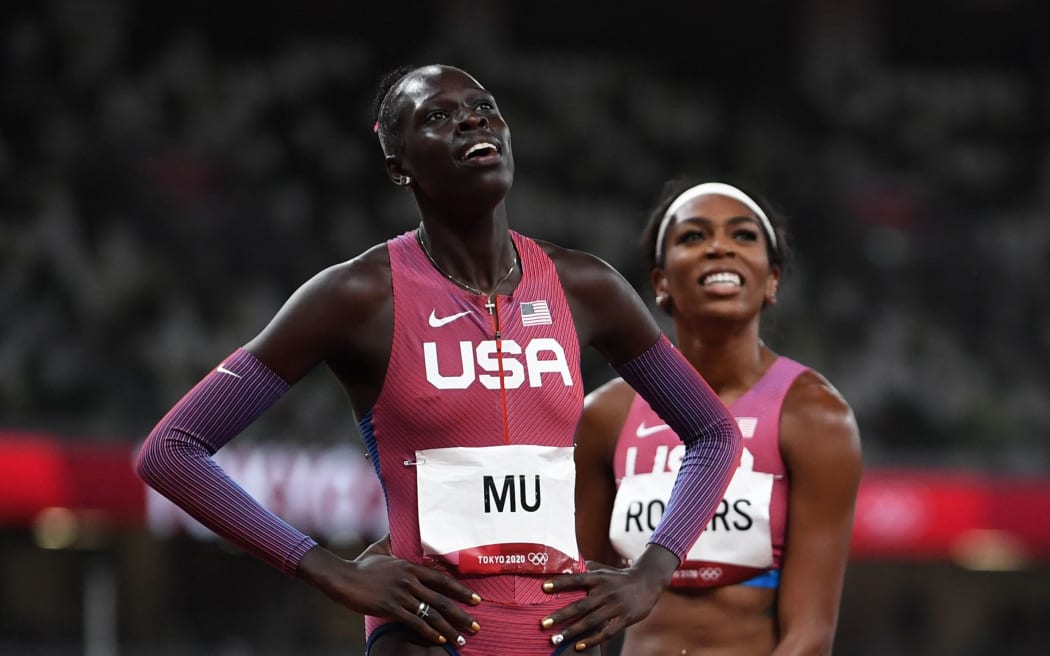 USA's Athing Mu (L) reacts after winning next to third-placed USA's Raevyn Rogers after the women's 800m final during the Tokyo 2020 Olympic Games at the Olympic Stadium in Tokyo on August 3, 2021.