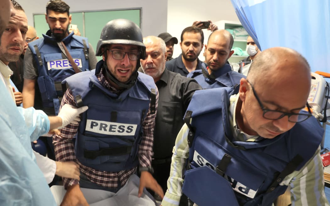 Journalists escort the body of veteran Al Jazeera journalist Shireen Abu Aqleh, who was shot dead as she covered a raid on the West Bank's Jenin refugee camp, on 11 May 2022, at the hospital in Jenin.