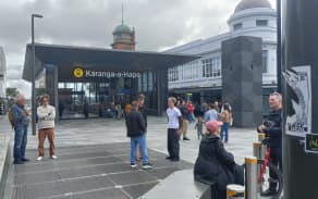 People outside the Karanga-a-Hape train station in Auckland, September 2026.