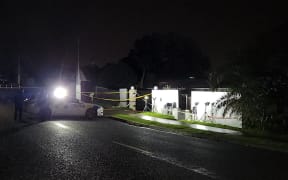 Police outside a house in in Henderson, West Auckland, where a woman was killed in a shooting.