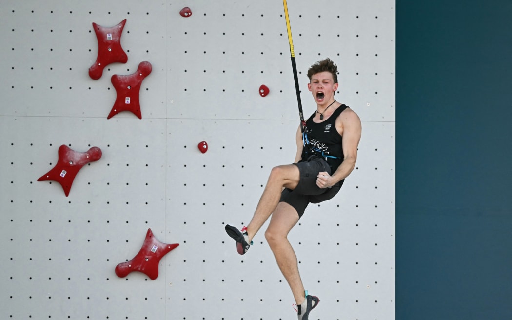 New Zealand's Julian David reacts as he competes in the men's sport climbing speed preliminary round's elimination heats during the Paris 2024 Olympic Games at Le Bourget Sport Climbing Venue in Le Bourget on August 6, 2024. (Photo by Fabrice COFFRINI / AFP)