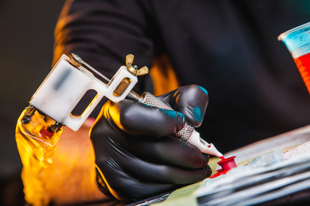 master tattoo artist prepares tools for tattooing