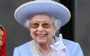Britain's Queen Elizabeth II reacts as she watches a special flypast from Buckingham Palace balcony following the Queen's Birthday Parade, the Trooping the Colour, as part of Queen Elizabeth II's platinum jubilee celebrations, in London on June 2, 2022. - Huge crowds converged on central London in bright sunshine on Thursday for the start of four days of public events to mark Queen Elizabeth II's historic Platinum Jubilee, in what could be the last major public event of her long reign. (Photo by Daniel LEAL / AFP)