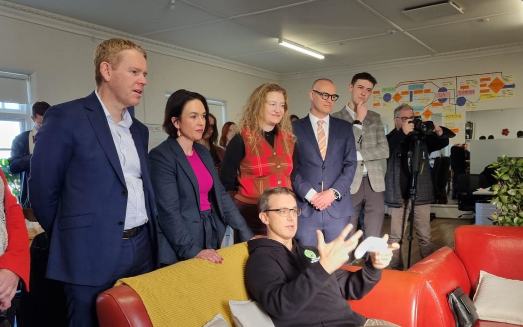 Chris Hipkins (left) and ministers with Balancing Monkey Games co-founder Sam Barham (seated) at the firm's gaming development studio in Dunedin.