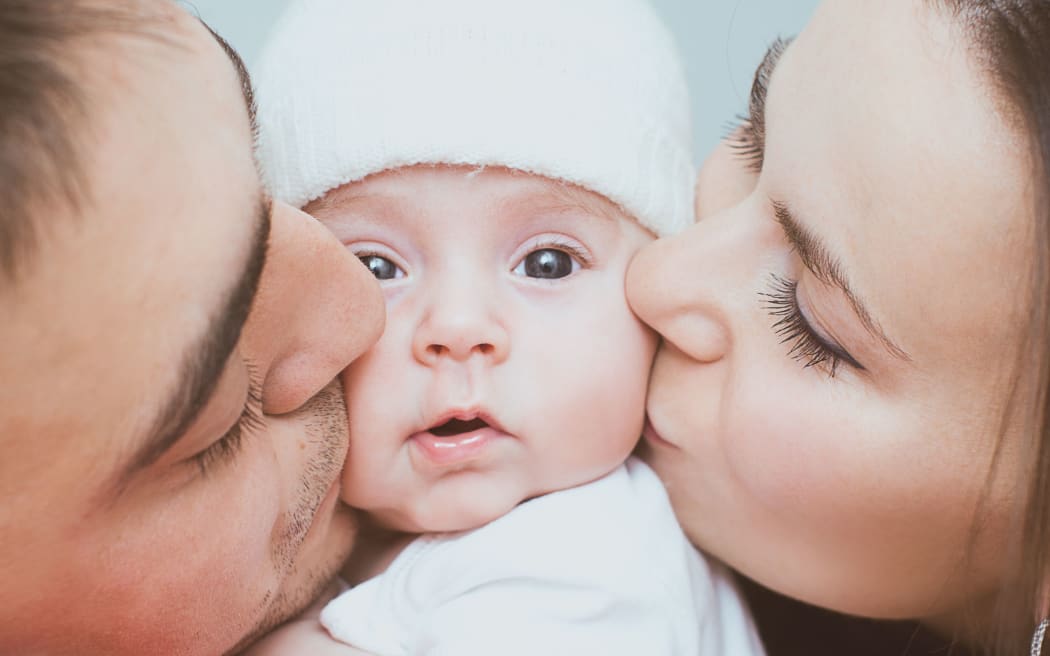 Young mother and father with newborn