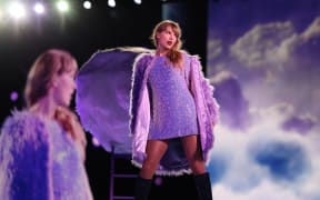 Taylor Swift on stage in the concert movie Taylor Swift: The Eras Tour