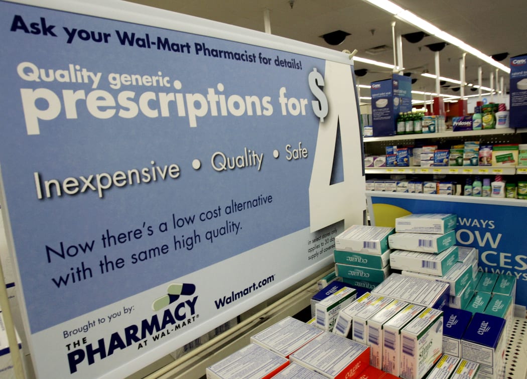 In this file photo taken on September 22, 2006, a large poster announces new prices inside the WalMart pharmacy in Clearwater, Florida.
