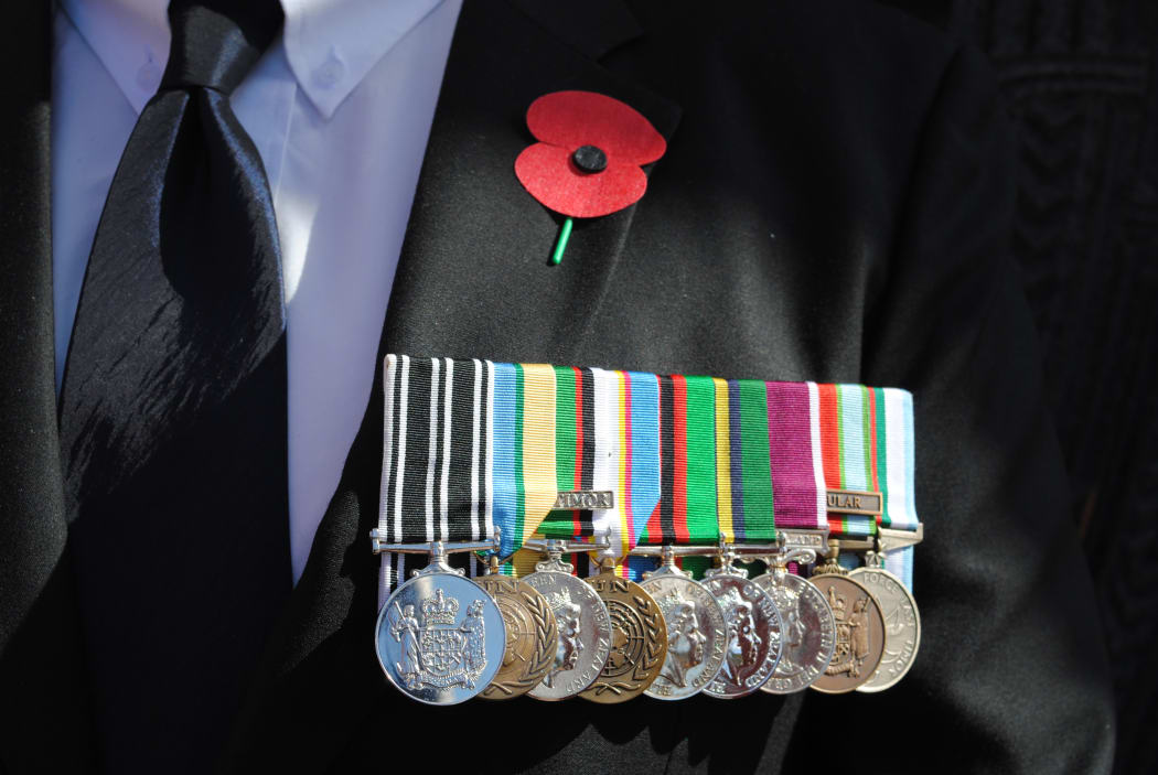 Remembrance poppy and medals on a veteran at the 50th commemoration of the Vietnam War held at Pukeahu National War Memorial, Wellington, in August.