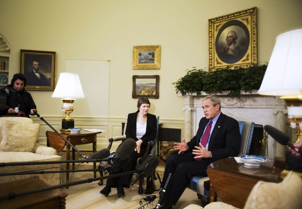 US President George W. Bush (R) speaks to the press during a meeting with New Zealand Prime Minister Helen Clark 21 March 2007 in the Oval Office.