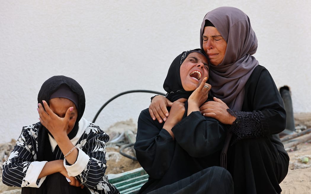Women cry as they mourn the death of a loved one killed during overnight Israeli bombardment on June 12, 2025, at Al-Shifa hospital in Gaza City, amid the ongoing war between Israel and the Palestinian Hamas militant group. (Photo by Omar AL-QATTAA / AFP)