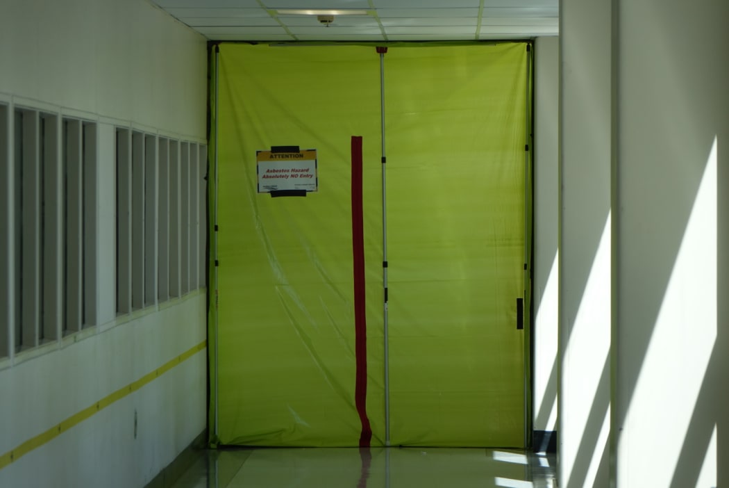 Asbestos warning sign on door