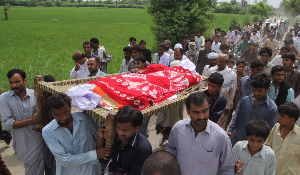 Pakistani relatives and residents carry the coffin of social media celebrity, Qandeel Baloch during her funeral in Shah Sadar Din village,