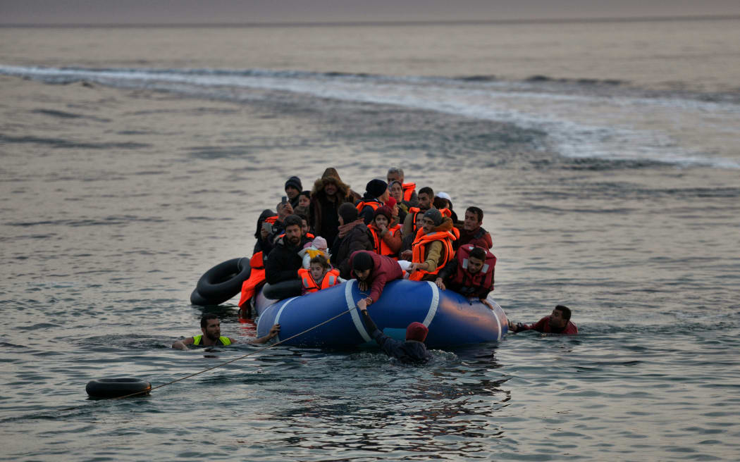 Refugees and migrants massed onto an inflatable boat reach Mytilene, northern island of Lesbos, after crossing the Aegean sea from Turkey last February.