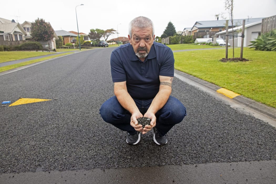 Colin Lawrence with a tiny portion of the stones that are tracked into his home and driveway daily.