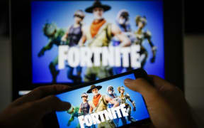 A man plays Fortnite game on smartphone in Ankara, Turkey on November 26, 2018. 
 Metin Aktas / Anadolu Agency